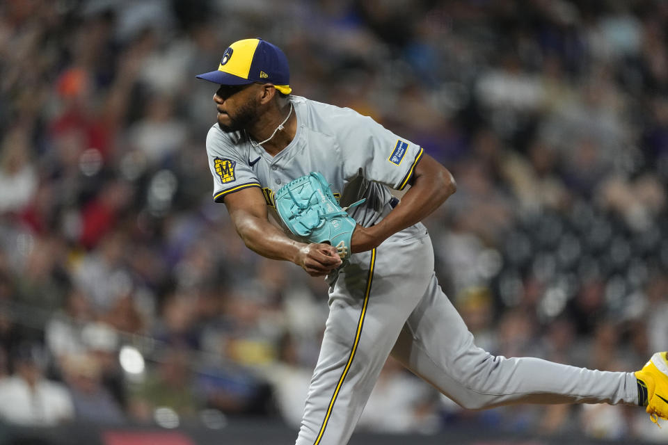 Milwaukee Brewers relief pitcher Elvis Peguero works against the Colorado Rockies in the eighth inning of a baseball game Monday, July 1, 2024, in Denver. (AP Photo/David Zalubowski)