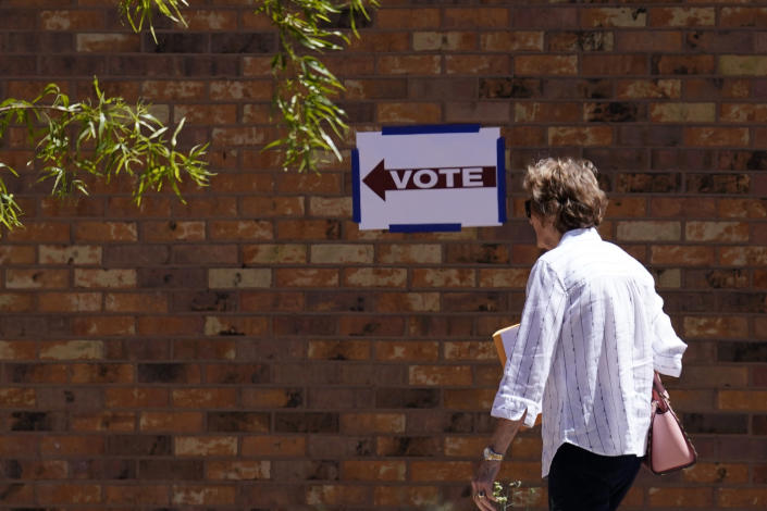 A voter heads into a polling stating as Arizona voters go the polls to cast their ballots, Tuesday, Aug. 2, 2022, in Tempe, Ariz. (AP Photo/Ross D. Franklin)