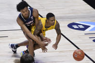 Virginia's Trey Murphy III, left, and San Francisco's Khalil Shabazz, chase a loose ball in the second half of an NCAA college basketball game, Friday, Nov. 27, 2020, in Uncasville, Conn. (AP Photo/Jessica Hill)