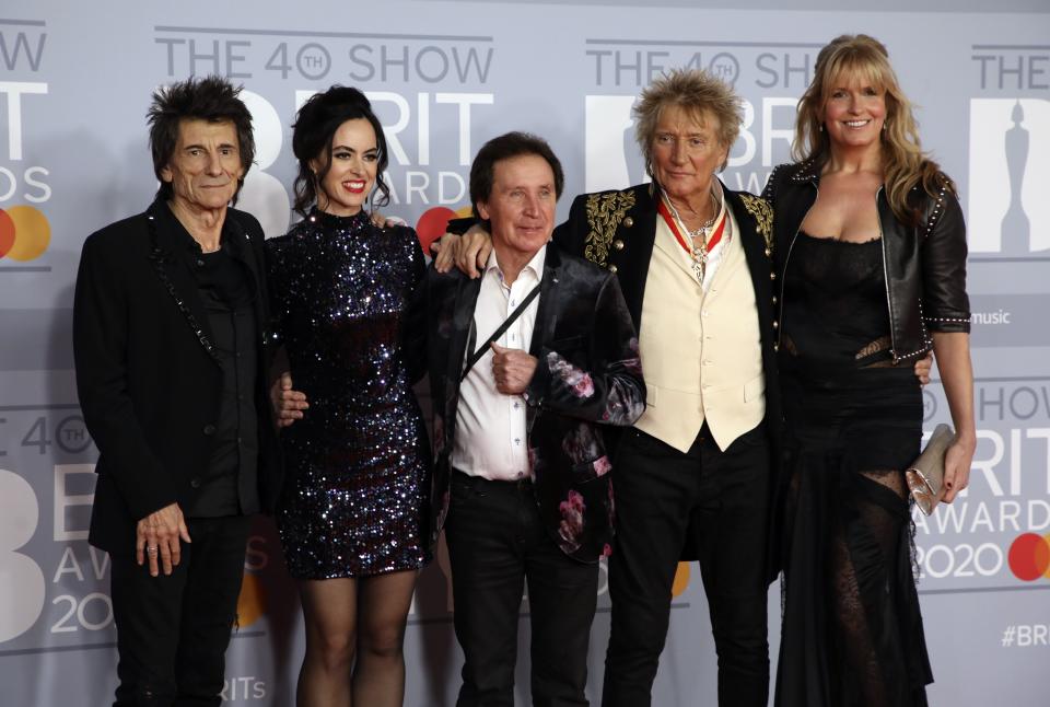 From left, Ronnie Wood, Sally Humphreys, Kenney Jones, Rod Stewart and Penny Lancaster pose for photographers upon arrival at Brit Awards 2020 in London, Tuesday, Feb. 18, 2020.(Photo by Vianney Le Caer/Invision/AP)