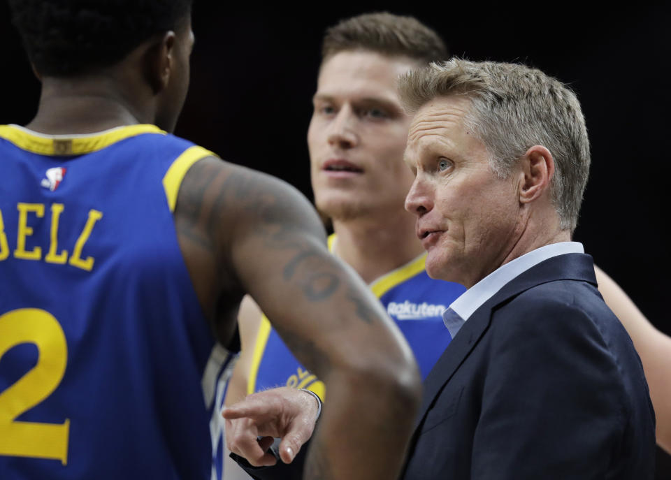Golden State Warriors head coach Steve Kerr, right, talks to his team during a timeout in the first half of Game 3 of the NBA basketball playoffs Western Conference finals against the Portland Trail Blazers, Saturday, May 18, 2019, in Portland, Ore. (AP Photo/Ted S. Warren)