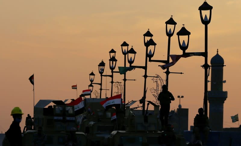 Iraqi army forces guard at Al Shuhada bridge during ongoing anti-government protests, in Baghdad