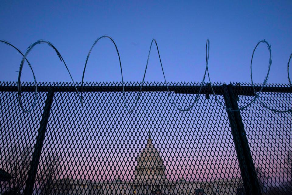 WASHINGTON, DC - FEBRUARY 08: The exterior of the U.S. Capitol building is seen through barbed wire fencing at sunrise on February 8, 2021 in Washington, DC. The Senate is scheduled to begin the second impeachment trial of former U.S. President Donald J. Trump on February 9. (Photo by Sarah Silbiger/Getty Images) ORG XMIT: 775619407 ORIG FILE ID: 1231044322