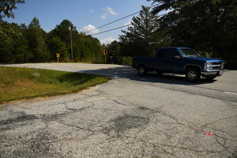 A driver passes by Freemans Bridge Road on Dacusville Road in Marietta, S.C., on Wednesday, Oct. 4. Freemans Bridge Road is on Greenville County's most recent paving list.