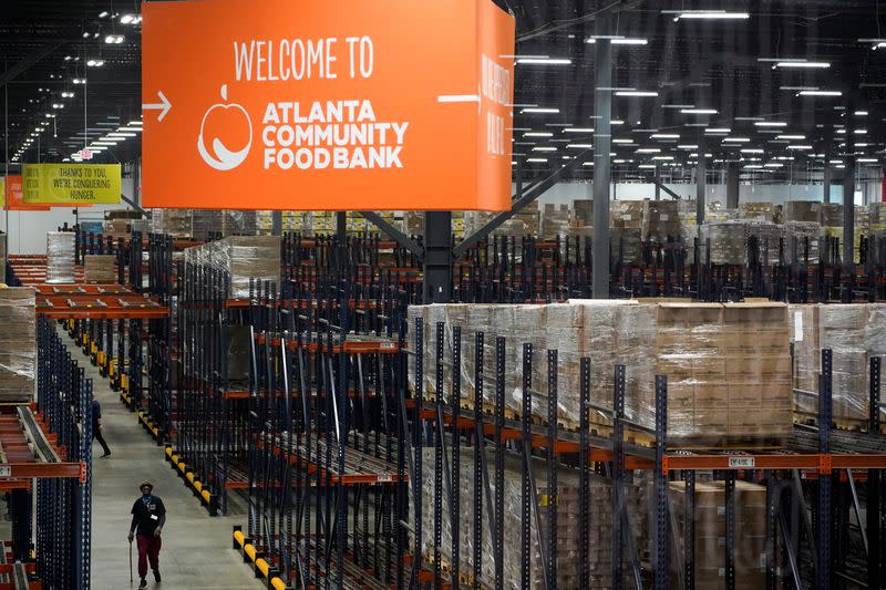A person walks through the nation's largest food bank warehouse, the Atlanta Community Food Bank, in Atlanta
