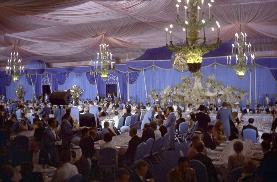 FILE - This Oct. 15, 1971 file photo, shows the interior of the banqueting tent during the celebrations to mark the 2,500 anniversary of the founding of the Persian Empire, in Persepolis, Iran. At the height of his power in 1971, Iran’s Shah Mohammad Reza Pahlavi drew world leaders to the wind-swept luxury tent city, offering a lavish banquet of food flown in from Paris to celebrate in the ruins of Persepolis. Only eight years later, his own empire would be in ruins. (AP Photo/Horst Faas, File)
