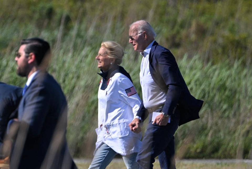 US president Joe Biden and US first lady Jill Biden make their way to board Marine One before departing from Gordons Pond in Cape Henlopen State Park in Rehoboth Beach, Delaware (AFP via Getty Images)