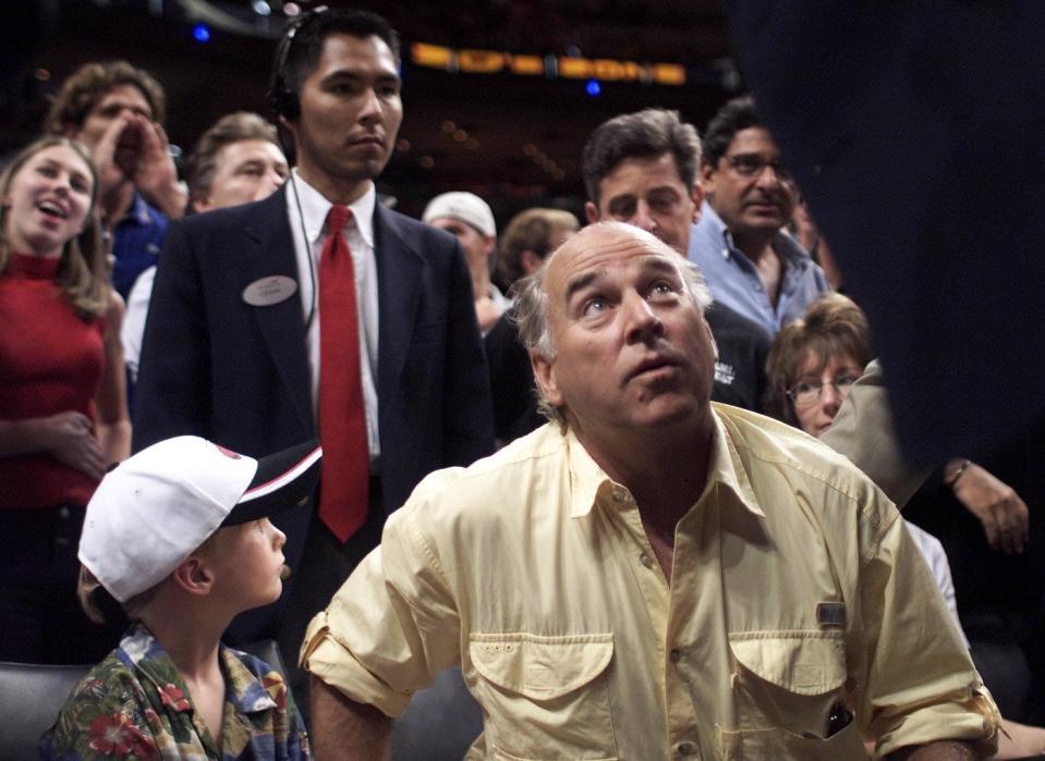 Jimmy Buffett and his son, Cameron, 6, are asked to leave courtside seats at the Heat/Knicks game on Feb. 4, 2001 at American Airlines Arena in Miami after officials tossed Buffett for complaining about the officiating.
