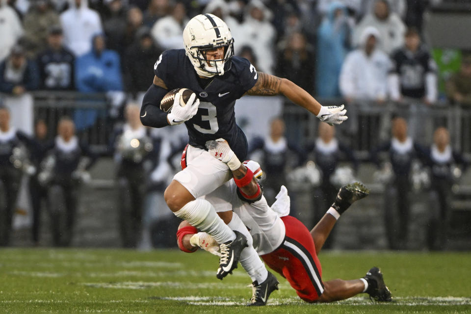 Penn State wide receiver Parker Washington is tackled by Maryland defensive back Dante Trader Jr. during the first half of an NCAA college football game, Saturday, Nov. 12, 2022, in State College, Pa. (AP Photo/Barry Reeger)