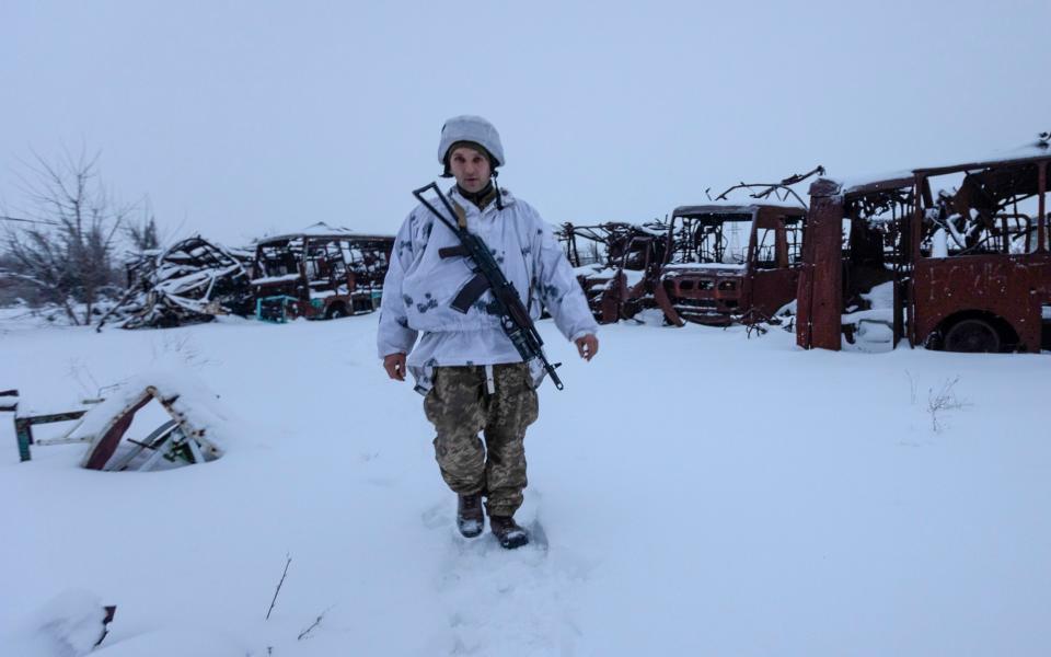 A Ukrainian soldier walks at the line of separation from pro-Russian rebels, Donetsk region, Ukraine - AP