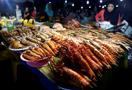Barbecued seafood for sale is seen at the Filipino Market in Kota Kinabalu, Sabah, Malaysia, July 4, 2018. REUTERS/Edgar Su/File Photo