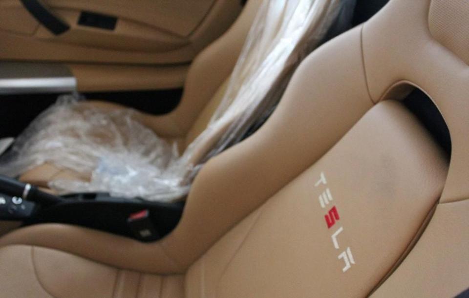 The tan interior of a 2010 Tesla Roadster that is now for sale.