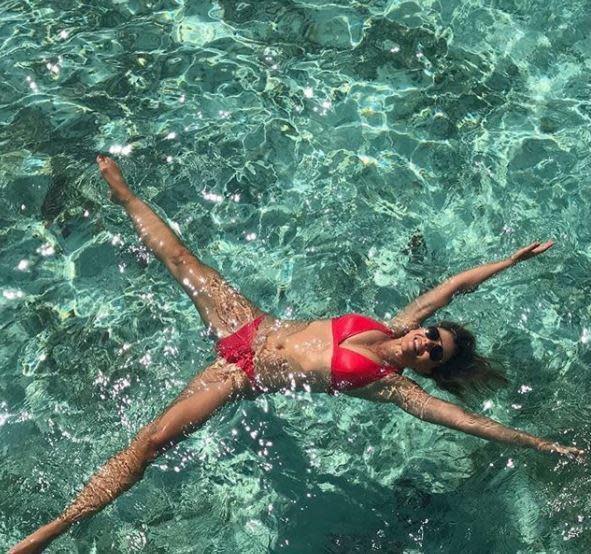 <p>Liz Hurley has shared another snap from her recent sun-soaked holiday to the Maldives. Seen splashing around in the crystal clear water she used the opportunity to spruik the tiny red bikini from her swimwear line.</p>