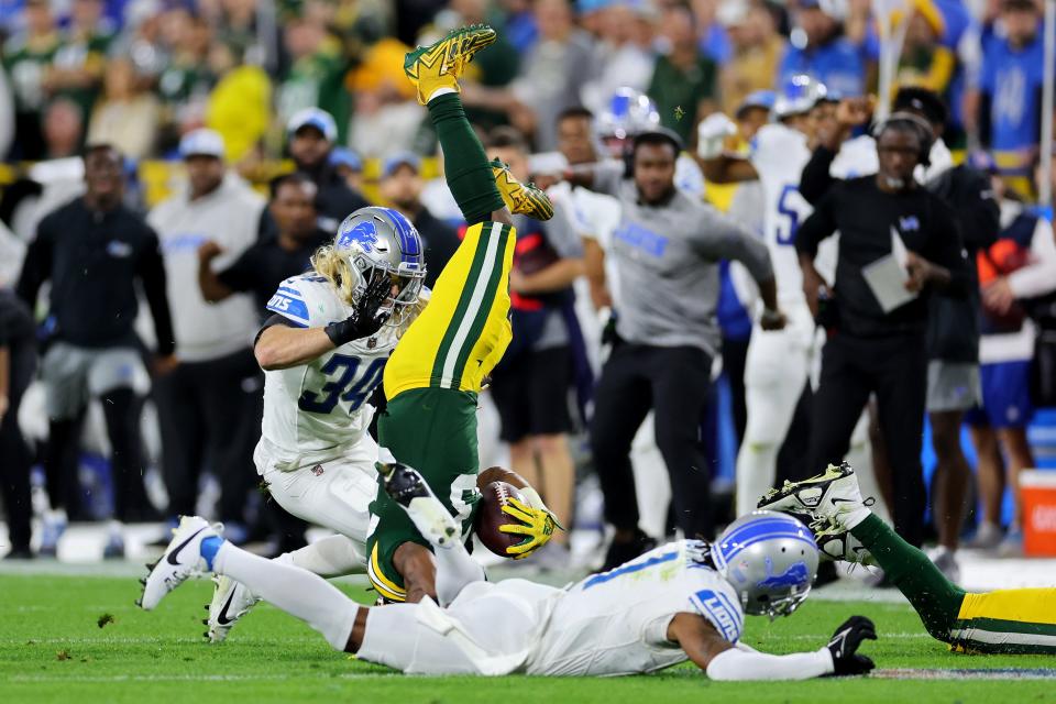 Packers running back Aaron Jones flips over after a play against the Lions during the second quarter on Thursday, Sept. 28, 2023, in Green Bay, Wisconsin.