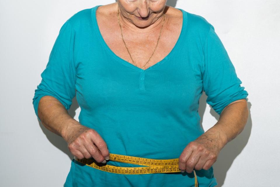 Hormonal changes and a slowing metabolism have been shown to contribute to fat accumulation during menopause, which is diagnosed when a woman has gone 12 months without a period. Shutterstock