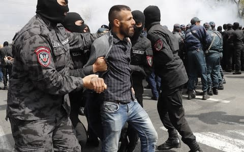 Police detain a man during protests in Yerevan on Sunday - Credit: Artyom Geodakyan/TASS via Getty Images