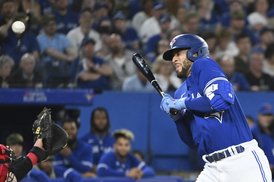 Toronto Blue Jays' George Springer is hit by a pitch from Cincinnati Reds' Hunter Strickland during the seventh inning of a baseball game Friday, May 20, 2022, in Toronto. (Jon Blacker/The Canadian Press via AP)