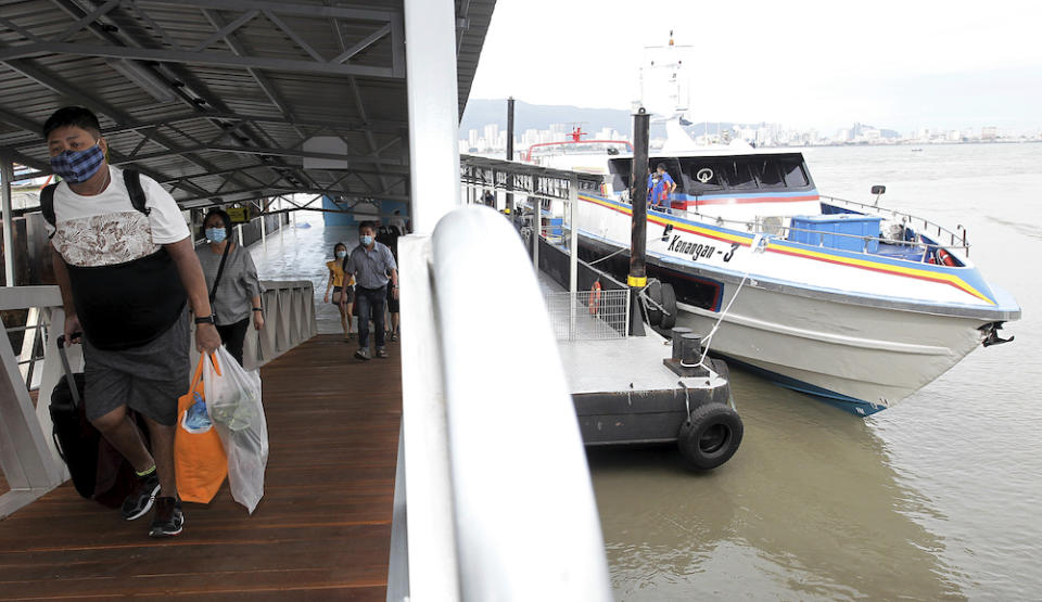 Passengers disembarking after their journey on the new speedboat from Swettenham Pier to Pengkalan Sultan Abdul Halim Ferry Terminal, January 1, 2021. — Picture by Sayuti Zainuddin