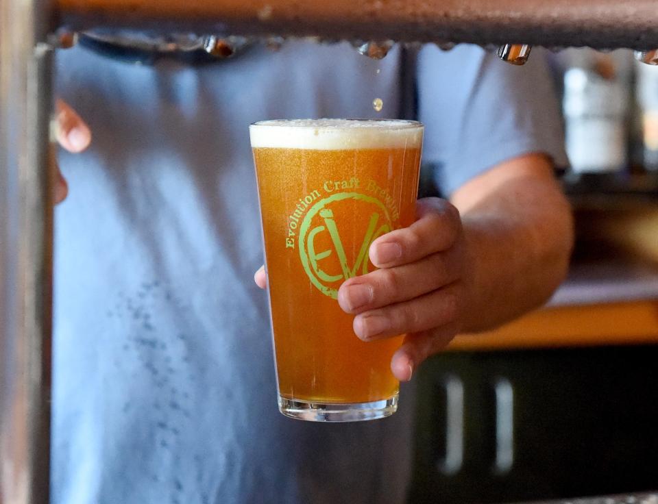 Tom Knorr, co-founder of Evolution Craft Brewing Company, pours a beer in the Tasting Room and Brewery Friday, Aug. 27, 2021, in Salisbury, Maryland.