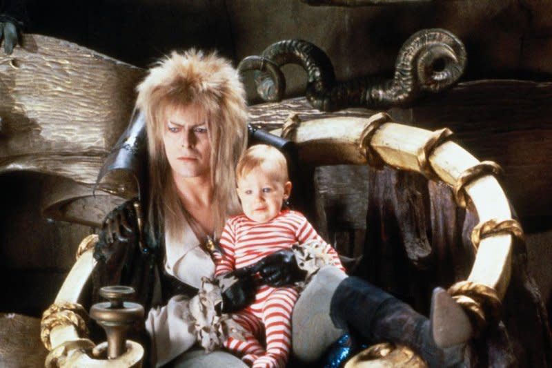 Jareth (David Bowie) holds Toby (Toby Froud) in his goblin kingdom. Photo courtesy of Shout! Studios and The Jim Henson Company