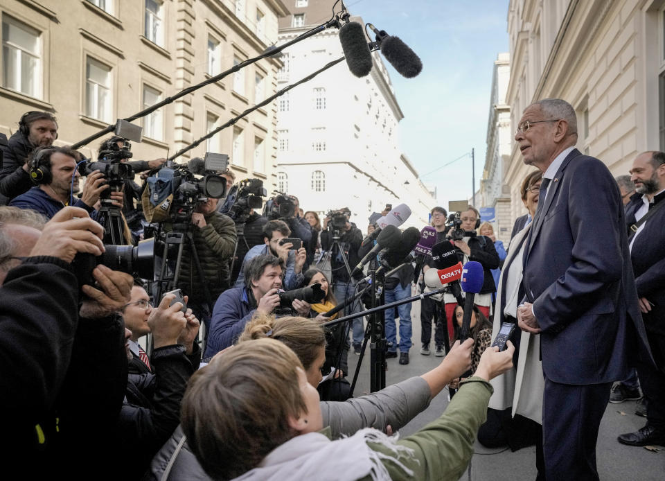 Austrian President Alexander Van der Bellen talks to media people after casting his vote for the Austrian Presidential election in Vienna, Austria, Sunday, Oct. 9, 2022. Austria's liberal president is hoping to be re-elected on Sunday without the need for a runoff vote after a campaign in which he has cast himself as the stable option in uncertain times. (AP Photo/Markus Schreiber)