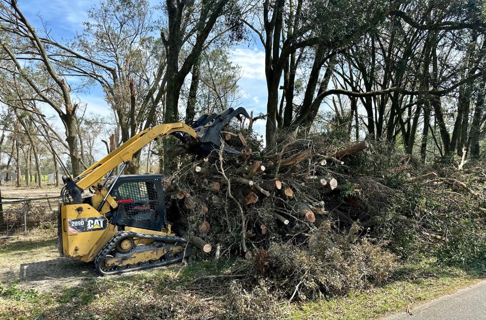 Crews remove a massive amount of fallen trees from a residence in rural Lafayette County, Florida, on Sept. 5, 2023, nearly a week after Hurricane Idalia made landfall.