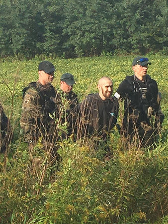 Fugitive Shawn Christy, 27, is arrested by law enforcement agents in Mifflin Township, Ohio, U.S. in this September 21, 2018 handout photo. He has been charged with threatening President Donald Trump. U.S. Marshal's Service/Handout via REUTERS