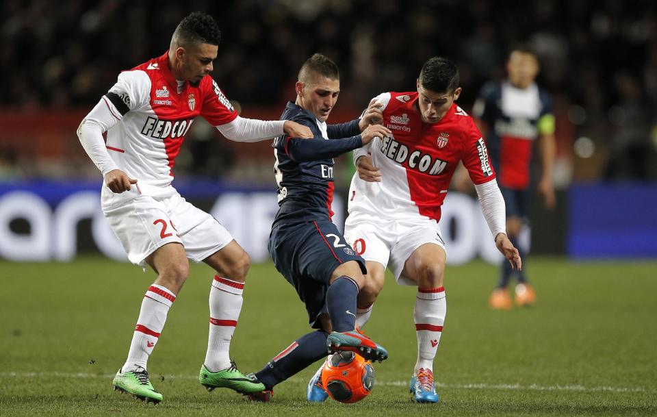 Paris Saint Germain's Marco Verratti of Italy, center, challenges for the ball with Monaco's Emmanuel Riviere of France, left, and Monaco's James Rodriguez of Colombia during their French League One soccer match, in Monaco stadium, Sunday, Feb. 9 , 2014. (AP Photo/Lionel Cironneau)