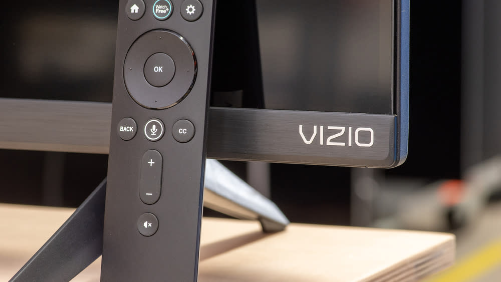  Vizio TV with remote in front on desk. 