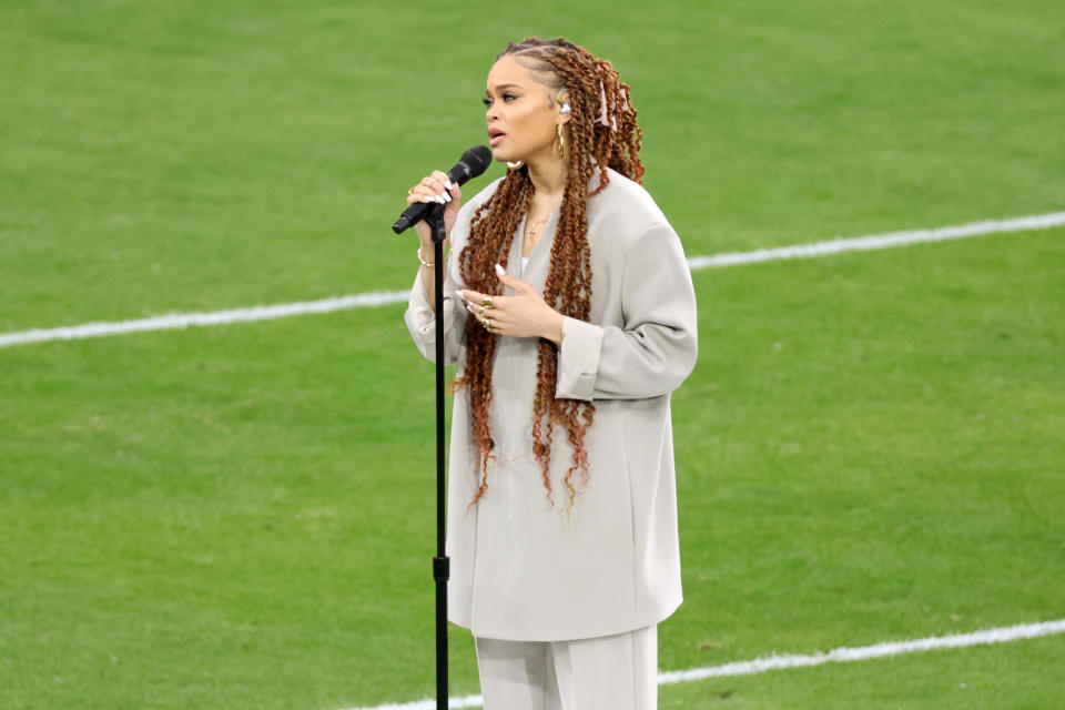 Andra Day sings on the field