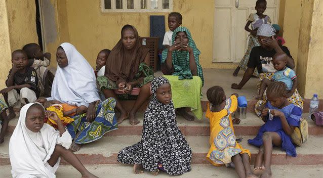 Women and children rescued by Nigerian soldiers wait to receive treatment at the refugee camp Photo: AP/ Sunday Alamba