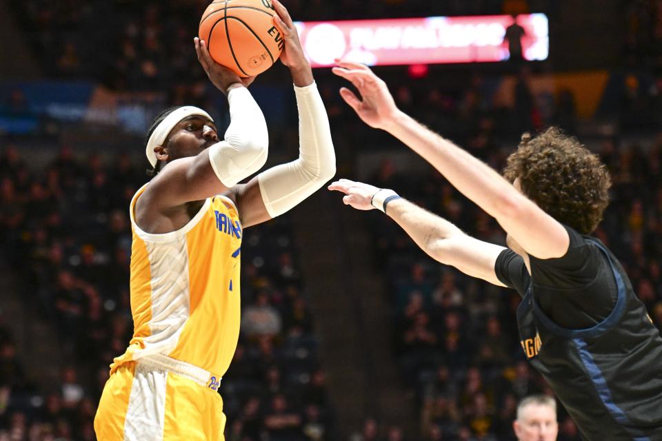 Pittsburgh forward Blake Hinson (2) shoots while being guarded by West Virginia forward Ofri Naveh (9) during the second half of an NCAA college basketball game Wednesday, Dec. 6, 2023, in Morgantown, W.Va. (William Wotring/The Dominion-Post via AP)