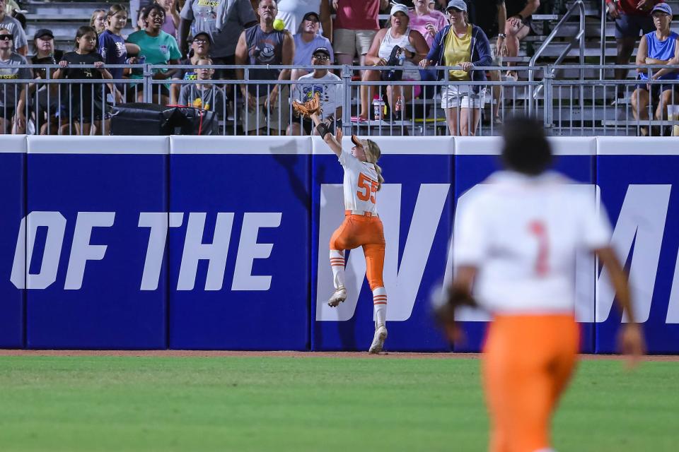 OSU outfielder Chelsea Alexander (55) jumps for a home run hit as the Oklahoma State Cowgirls face the Texas Longhorns in the second game of the 2022 Women's College World Series semifinal at USA Softball Hall of Fame Complex in Oklahoma City on Monday, June 6, 2022.