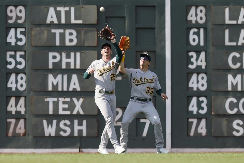 Oakland Athletics' Brent Rooker (25) makes the catch beside JJ Bleday (33) on a fly out by Boston Red Sox's Alex Verdugo during the second inning of a baseball game, Saturday, July 8, 2023, in Boston. (AP Photo/Michael Dwyer)