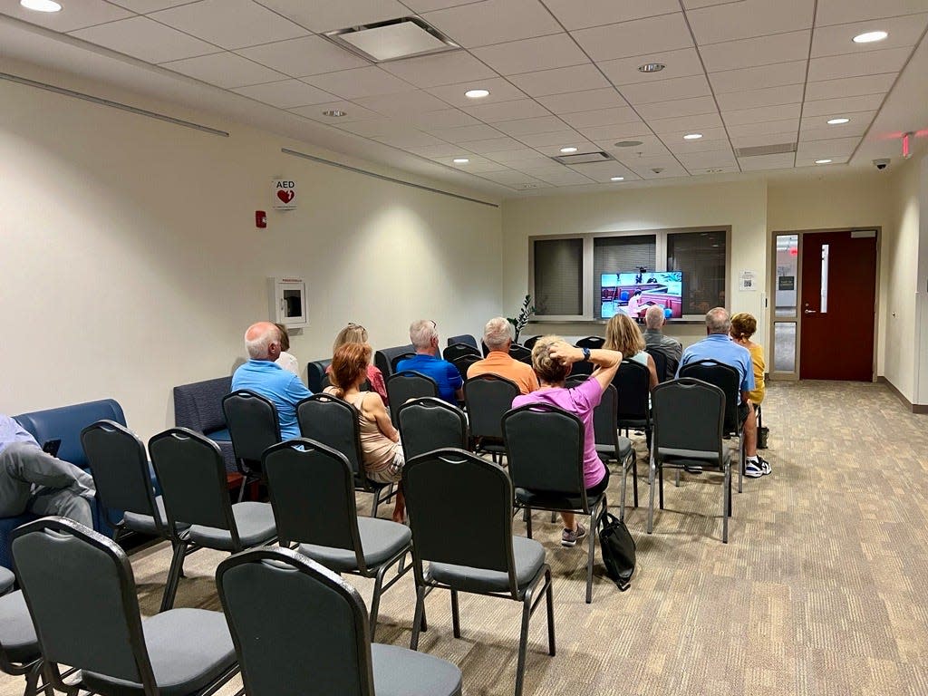 Some residents sat on the second floor of Leland Town Hall watching the town council's April 18 meeting live online as it happened in the nearby council chambers.