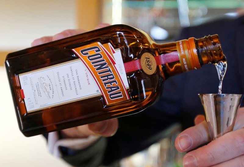 FILE PHOTO: A man pours Remy Cointreau into a glass at the Remy Martin factory in Cognac