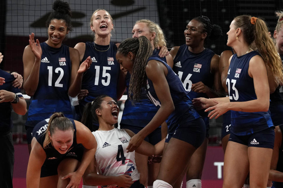 United States players celebrate winning the women's volleyball quarterfinal match between Dominican Republic and United States at the 2020 Summer Olympics, Wednesday, Aug. 4, 2021, in Tokyo, Japan. (AP Photo/Frank Augstein)