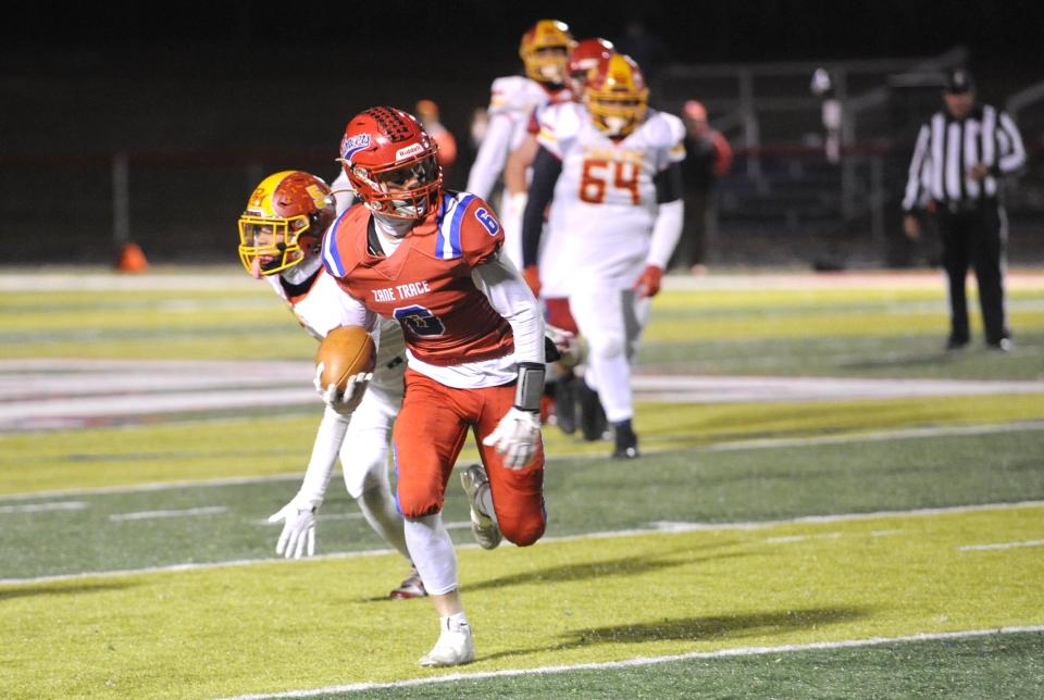 Zane Trace's Aaden Dunn gains yardage during the Pioneers' Division V regional quarterfinal against the Purcell Marian Cavaliers on Friday in Kinnikinnick, Ohio. Purcell Marian won the game 30-28.