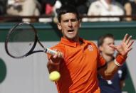 Novak Djokovic of Serbia returns the ball to Rafael Nadal of Spain during their men's quarter-final match during the French Open tennis tournament at the Roland Garros stadium in Paris, France, June 3, 2015. REUTERS/Jean-Paul Pelissier