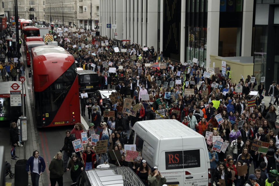 Youngsters march through traffic as they take part in a student climate protest in London, Friday, March 15, 2019. Students in more than 80 countries and territories worldwide plan to skip class Friday in protest over their governments' failure to act against global warming. The coordinated 'school strike' was inspired by 16-year-old activist Greta Thunberg, who began holding solitary demonstrations outside the Swedish parliament last year. (AP Photo/Matt Dunham)