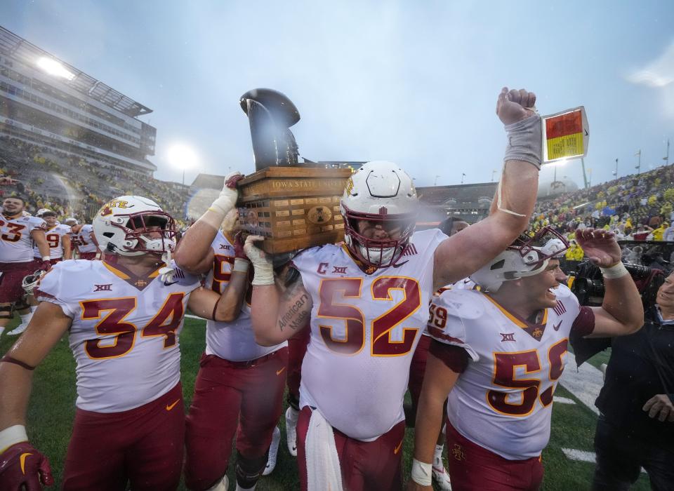 Members of the Iowa State Cyclones football team celebrate a 10-7 win over Iowa during the Cy-Hawk Series football game on Saturday at Kinnick Stadium in Iowa City.