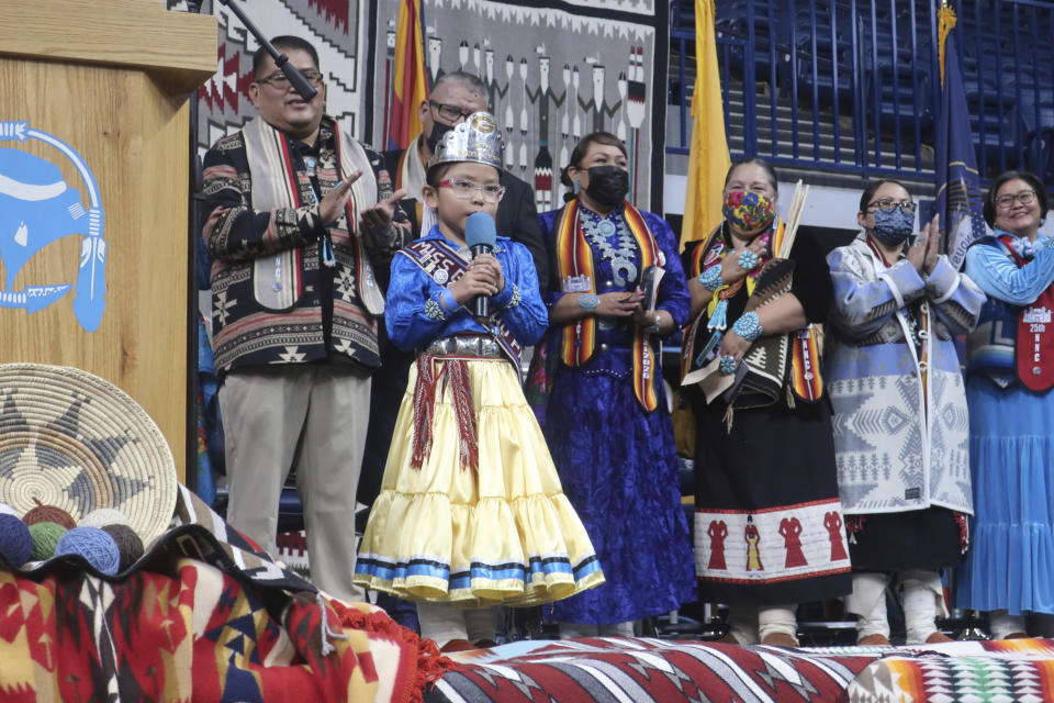 Miss Ganado Primary Princess Jewels E. Jones recites the pledge of allegiance in Navajo during the tribal inauguration Tuesday, Jan. 10, 2023 in Fort Defiance, Ariz. Navajo President Buu Nygren is the youngest person elected to the position, while Vice President Richelle Montoya is the first woman to hold that office. (AP Photo/Felicia Fonseca)