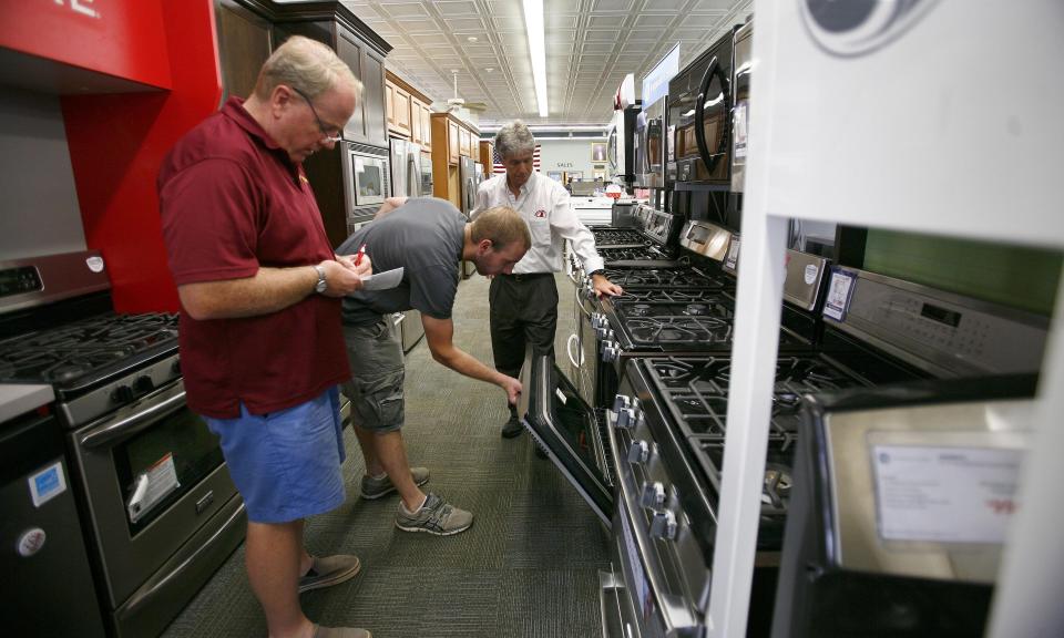 Brian and Thomas Haggerty look over an oven during tax-free weekend at George Washington Toma TV and Appliances in Weymouth in 2014. Greg Derr/The Patriot Ledger