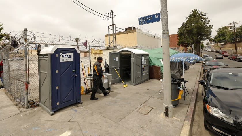 LOS ANGELES, CA - JUNE 07, 2019 - Deandre Fradiue works as the ambassador/attendant for Pit Stop that manages portable toilets for homeless people installed at Oakwood and Madison Avenues in East Hollywood on June 07, 2019. Deandre keeps track of how many people use the facility and cleans and sanitizes the toilets after each use. (Al Seib / Los Angeles Times)