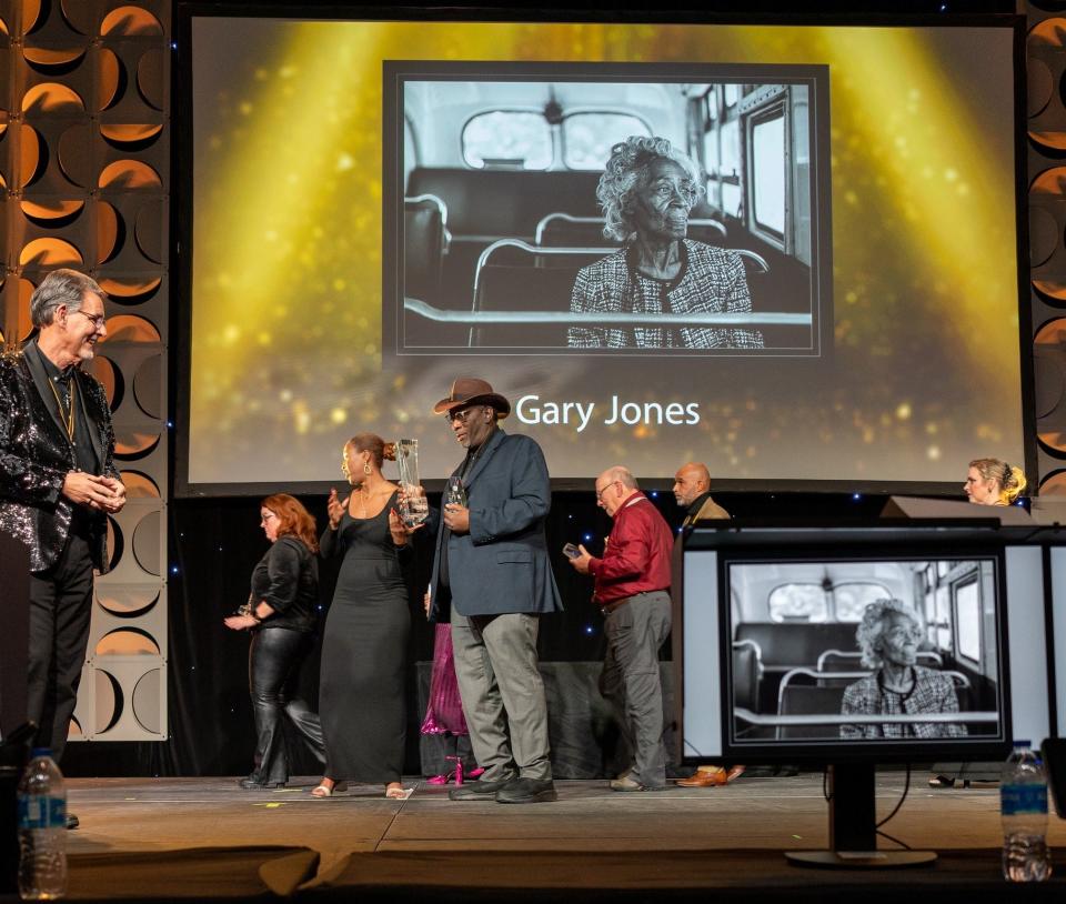 International Photographic Competition PPA Grand Imaging Award winner Gary D. Jones carries his two trophies at 2024 Imaging USA Convention in Louisville, Ky. held January 28-30.