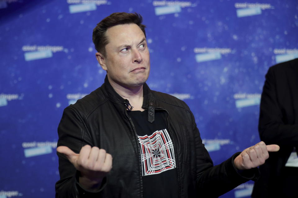 SpaceX owner and Tesla CEO Elon Musk arrives on the red carpet for the Axel Springer media award, in Berlin, Germany, Tuesday, Dec. 1, 2020. (Hannibal Hanschke/Pool via AP)