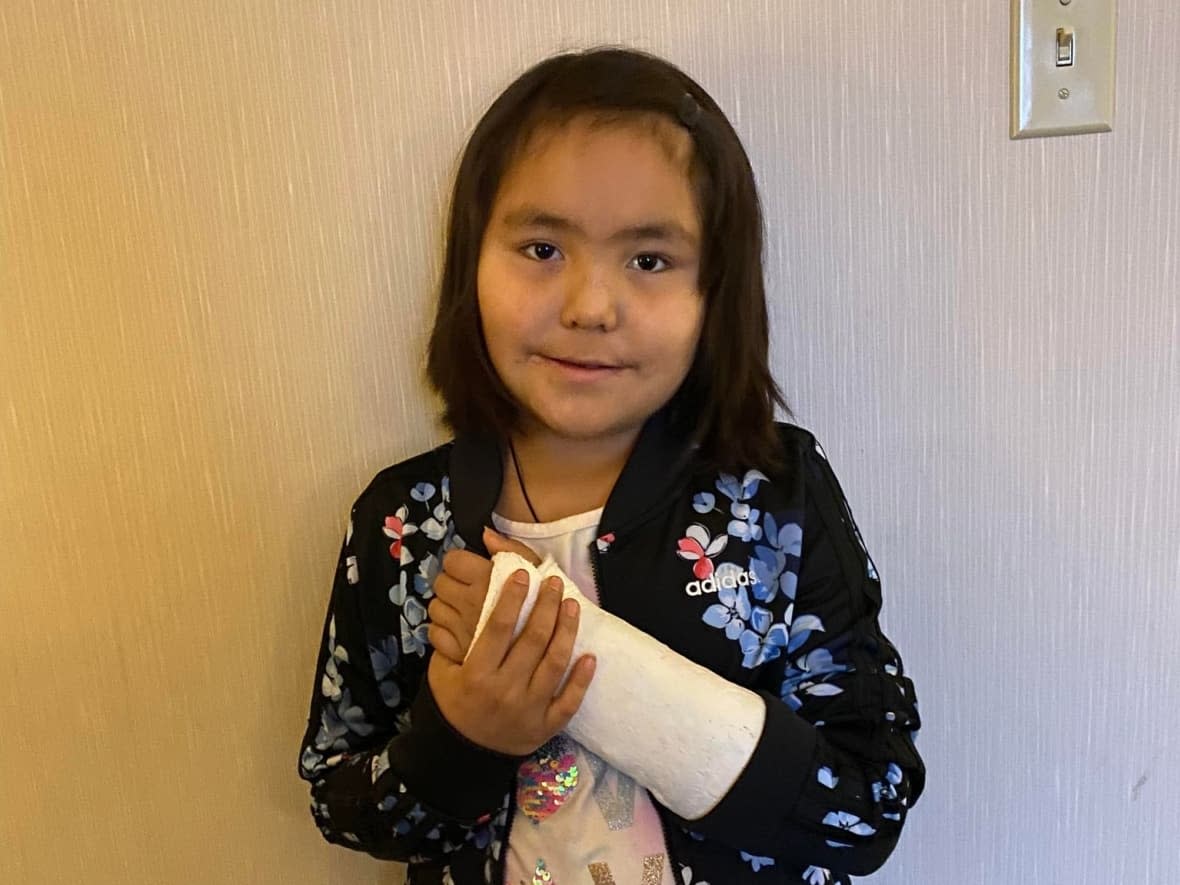 Etoah Lamalice, 7, fell off a snowmobile in Sambaa K'e, N.W.T., on Nov. 9. It was three weeks before she was able to get an X-ray in Yellowknife to confirm she broke a bone in her arm. Mother Valerie Lamalice is calling for better communication in the health-care system to keep this from happening again.  (Submitted by Valerie Lamalice - image credit)