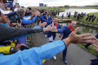 Golf - 2018 Ryder Cup at Le Golf National - Guyancourt, France - September 30, 2018. Team Europe's Ian Poulter and Sergio Garcia shake hands with fans as they celebrate after winning the Ryder Cup REUTERS/Regis Duvignau