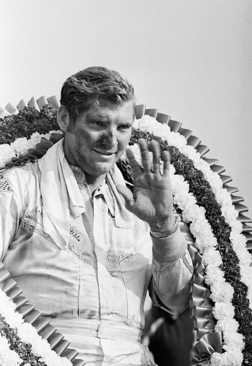 Richard Brickhouse of Rocky Point, N.C. , waves after getting his trophy and horseshoe of flowers in Victory Lane at Alabama International Raceway after winning the Talladega 500, in Talladega, Ala., Sept 14, 1969. (AP Photo)