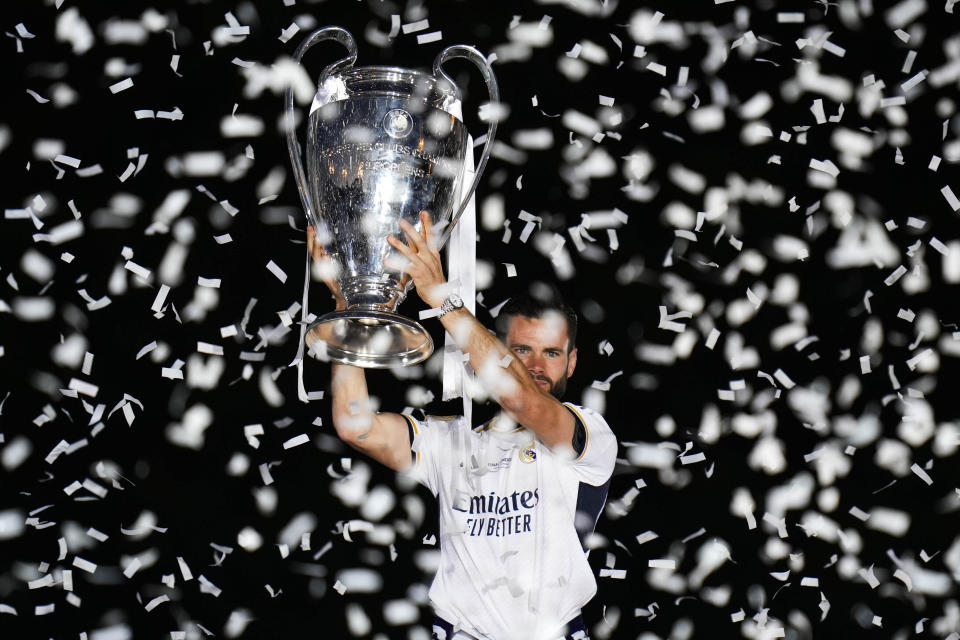 Real Madrid's Dani Carvajal holds the Champions League trophy at the Cibeles square during a trophy parade in front of the City Hall in Madrid, Spain, Sunday, June 2, 2024. Real Madrid won against Borussia Dortmund 2-0. (AP Photo/Bernat Armangue)